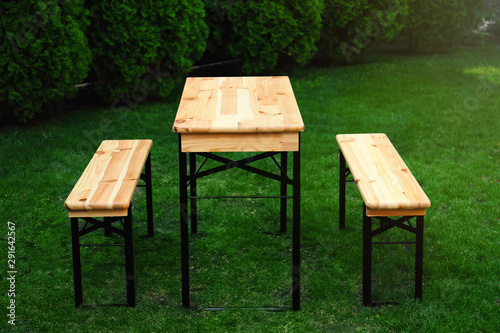Wooden picnic table with benches in park © New Africa