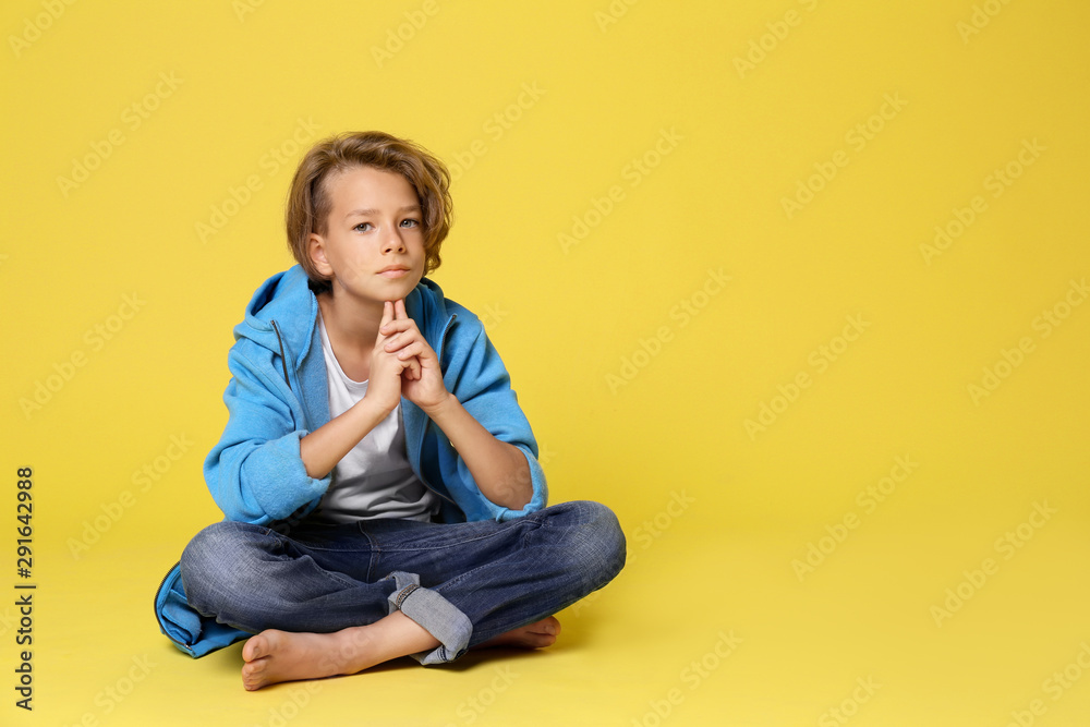 Cute little boy in casual outfit on yellow background. Space for text Cute little boy in casual outfit on yellow background. Space for text
