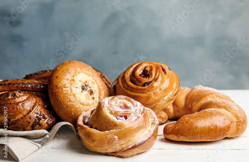 Different delicious fresh pastries on white wooden table