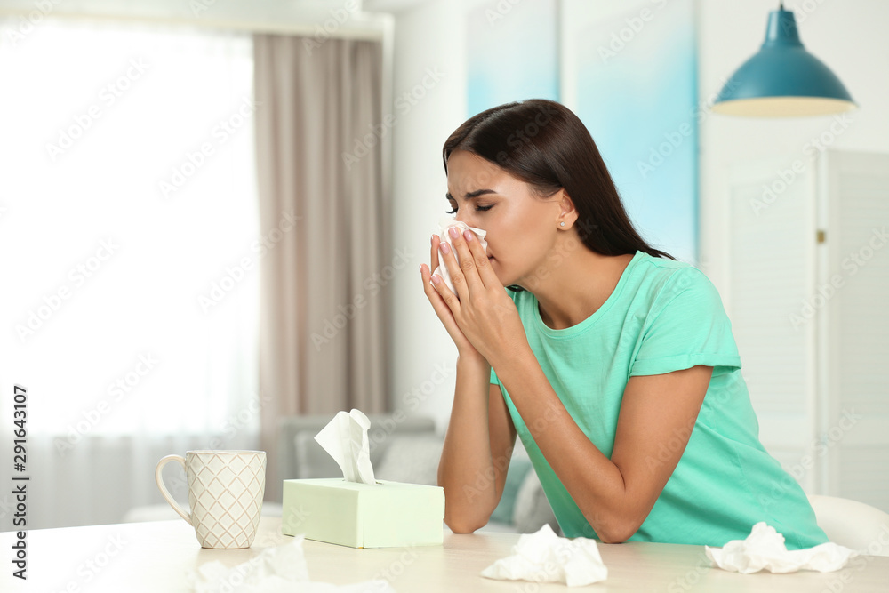 Young woman suffering from allergy at home Young woman suffering from allergy at home