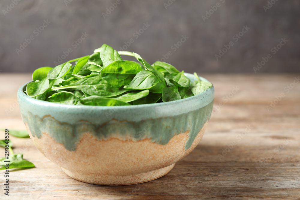 Fresh green healthy spinach on wooden table Fresh green healthy spinach on wooden table