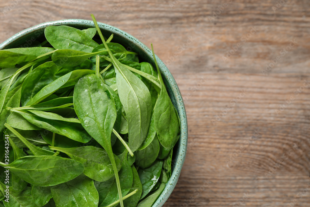 Fresh green healthy spinach on wooden table, top view. Space for text Fresh green healthy spinach on wooden table, top view. Space for text