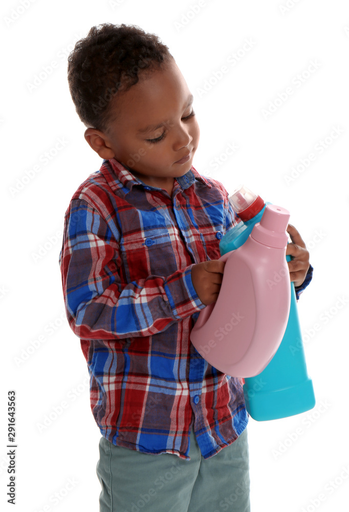 Little African-American boy playing with detergents on white background. Danger at home Little African-American boy playing with detergents on white background. Danger at home