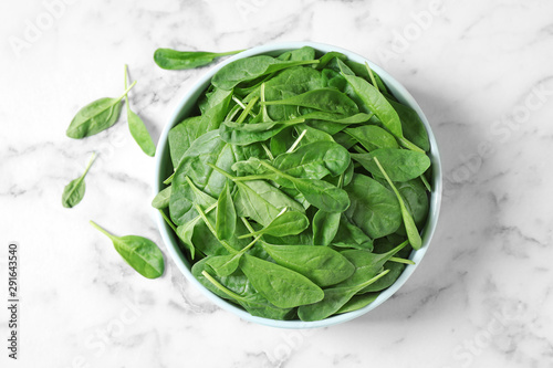 Fresh green healthy spinach on marble table, flat lay