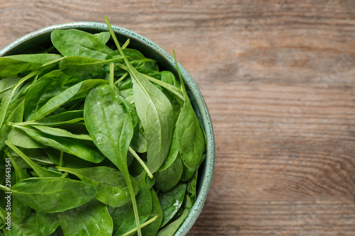 Fresh green healthy spinach on wooden table, top view. Space for text