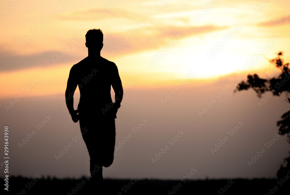 Young man running outdoors in evening. Space for text Young man running outdoors in evening. Space for text