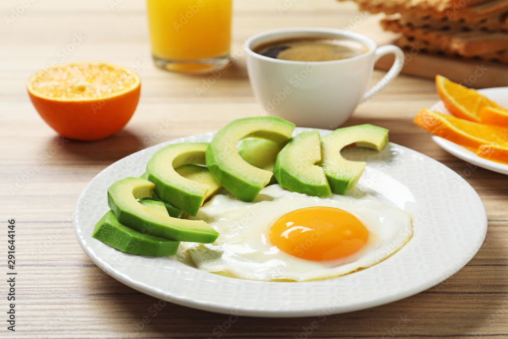 Delicious breakfast with fried egg served on wooden table Delicious breakfast with fried egg served on wooden table