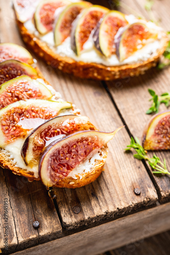 Sandwich with figs, cheese, honey and thyme. Selective focus. Shallow depth of field.
