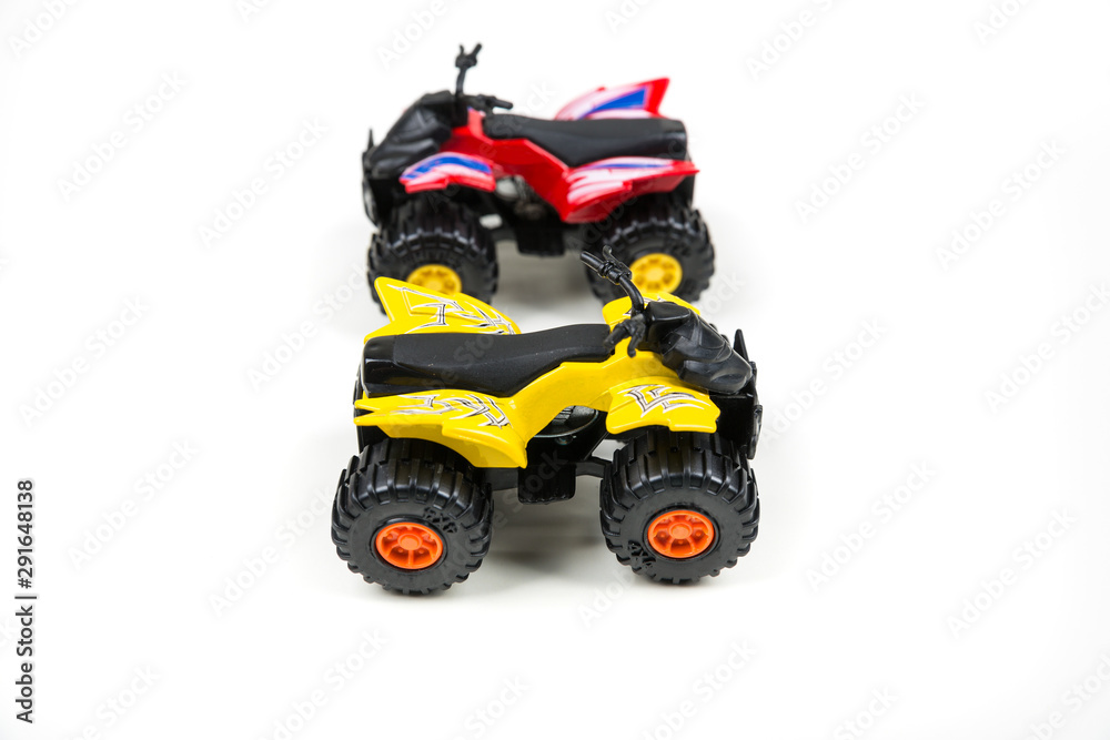 Red and yellow toy plastic quad atv on a white background Red and yellow toy plastic quad atv on a white background
