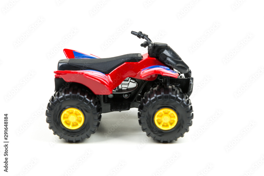 Red toy plastic quad atv on a white background Red toy plastic quad atv on a white background