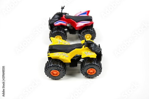 Red and yellow toy plastic quad atv on a white background