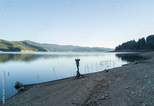 Young woman is enjoying the view of the lake