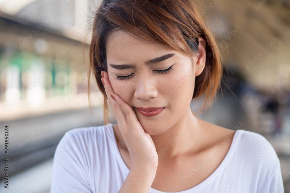 woman with toothache; sick asian woman suffering from toothache, tooth decay, tooth sensitivity, cavity, dental care concept; young adult asian woman model