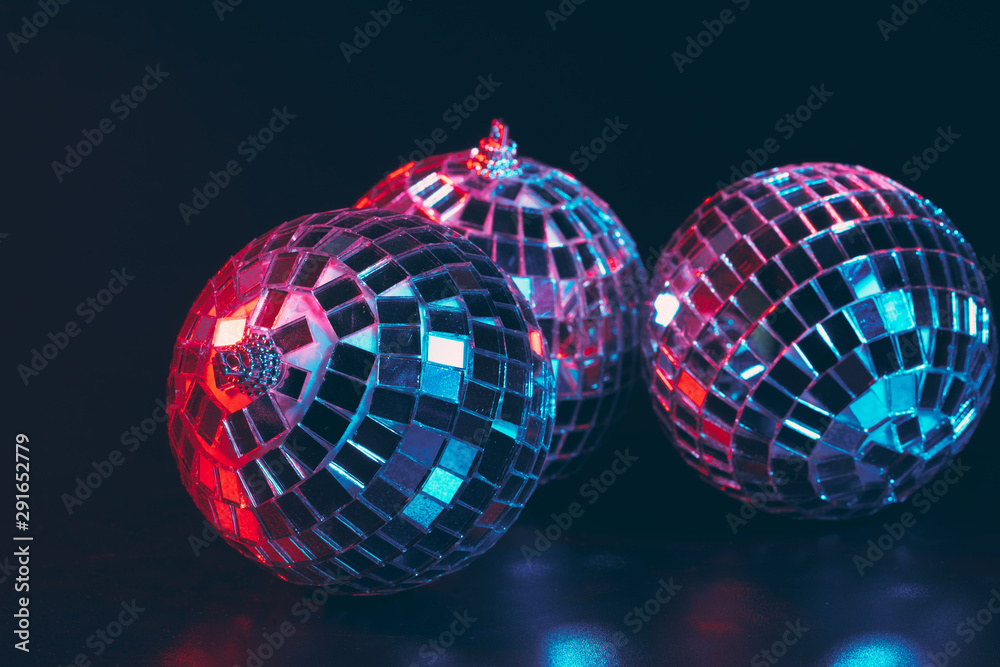 Group of shiny Disco Balls on dark background close up