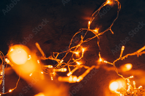 Warm light illuminated garland close up on dark background