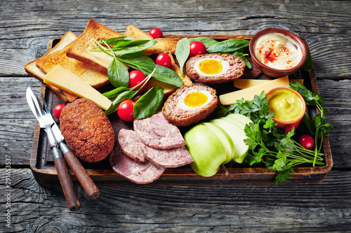 ploughman's lunch on a wooden board, close-up photo