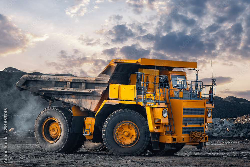 Big yellow mining truck laden anthracite moves open pit coal mine