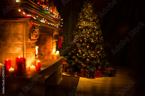 Christmas decorated living room interior with fireplace and xmas tree