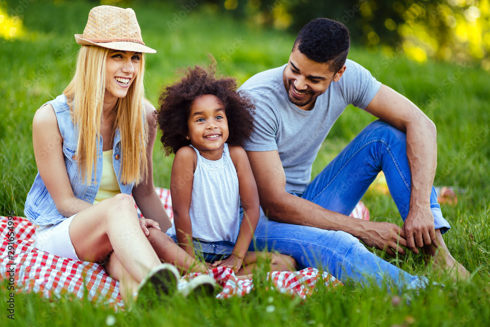 Picture of lovely couple with their daughter having picnic Picture of lovely couple with their daughter having picnic