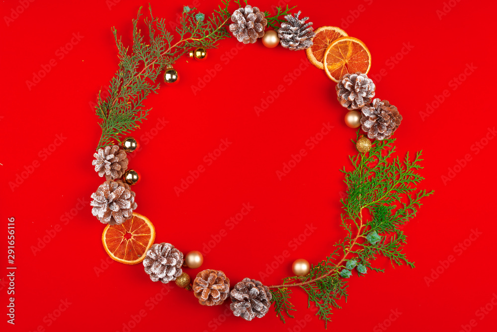Christmas wreath out of cone and pine on red background
