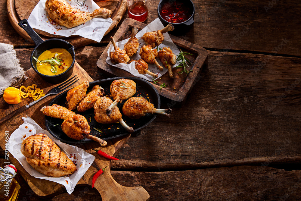 Assorted grilled chicken portions on a buffet Assorted grilled chicken portions on a buffet