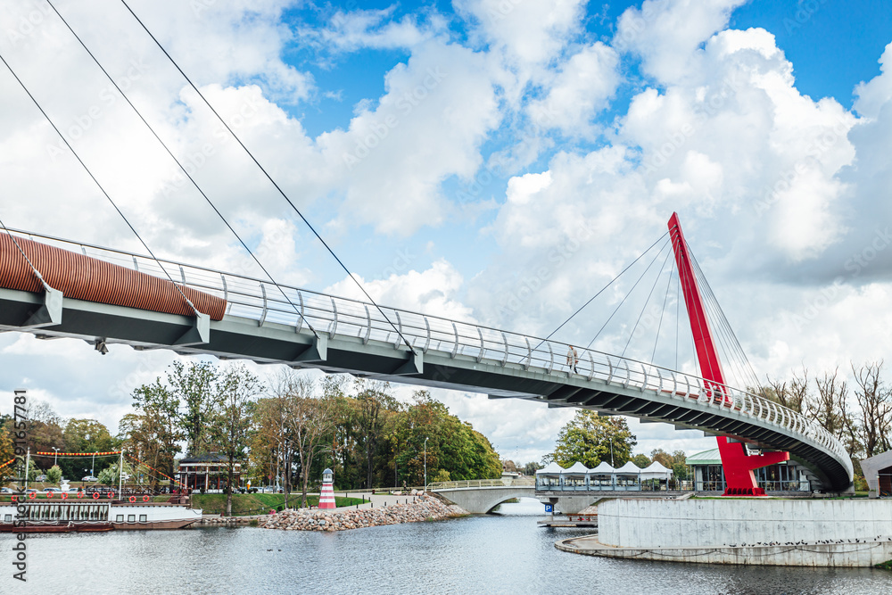 Modern pedestrian bridge over river in city of Jelgava.