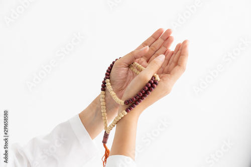 Young female muslim beautiful hands prayer to God front of white background concept for eid mubarak, pray for life and soul fasting of international islamic ramadan. photo