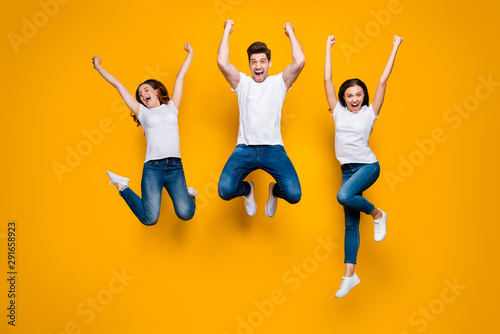 Full length body size view portrait of three nice attractive lovely slim strong sporty satisfied overjoyed cheerful cheery person having fun isolated over bright vivid shine yellow background