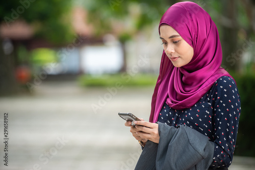 Muslim Woman with her smartphone. Outdoor Setting