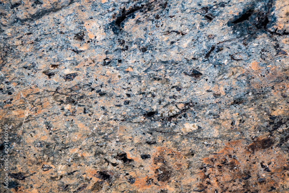 The texture of the stone overgrown with moss. Background image of a boulder The texture of the stone overgrown with moss. Background image of a boulder