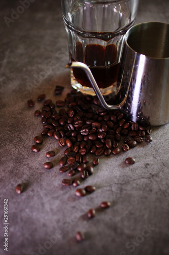 glass of drip coffee and beans on loft background