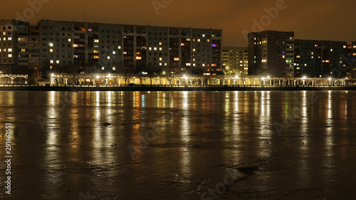 City embankment at night. Lights in the windows of apartments and lanterns. Winter is coming. © es0lex