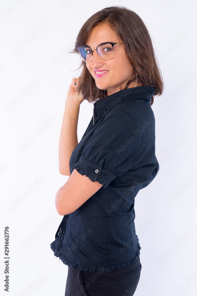 Profile view of happy beautiful businesswoman with eyeglasses looking at camera