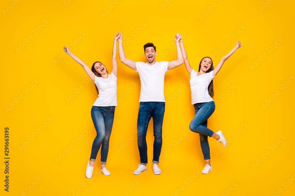 Full size photo of content fellows raising hands screaming standing isolated over yellow background
