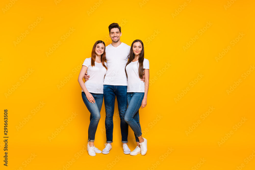 Full size photo of handsome people standing wearing white t-shirt denim jeans isolated over yellow background Full size photo of handsome people standing wearing white t-shirt denim jeans isolated over yellow background