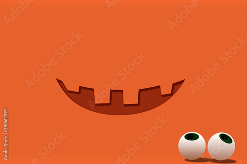 Halloween concept. Jack Lantern smile on pumpkin color background with eyes lying separately. Funny holiday backdrop. Copy space for your text.