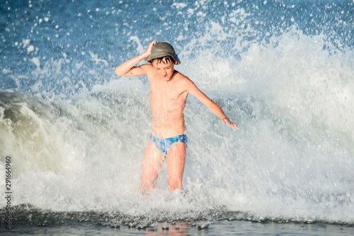 Boy in the spray of waves.