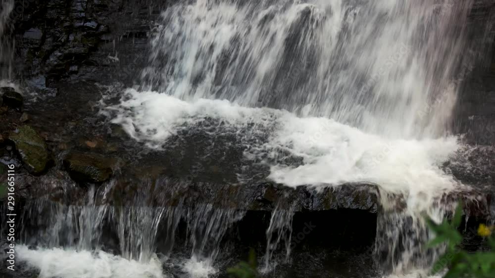 Close up of small mountain waterfall on the rocks. Waterfall mountain stream close up. Close up of small mountain waterfall on the rocks. Waterfall mountain stream close up.