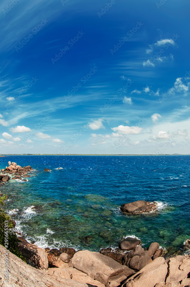 Beautiful seascape with clear water and blue sky with clouds. Sri Lanka.