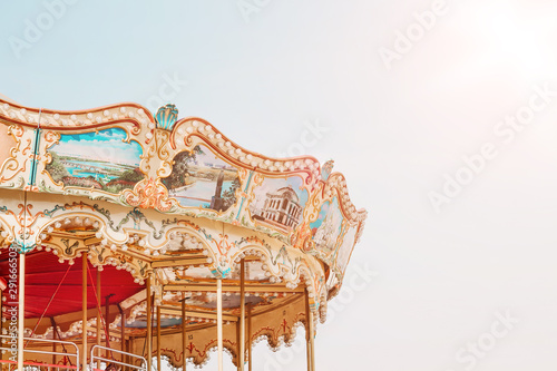 Beautiful bright carousel on blue sky background. Сarousel fragment with copy space. Festival. Holiday.
