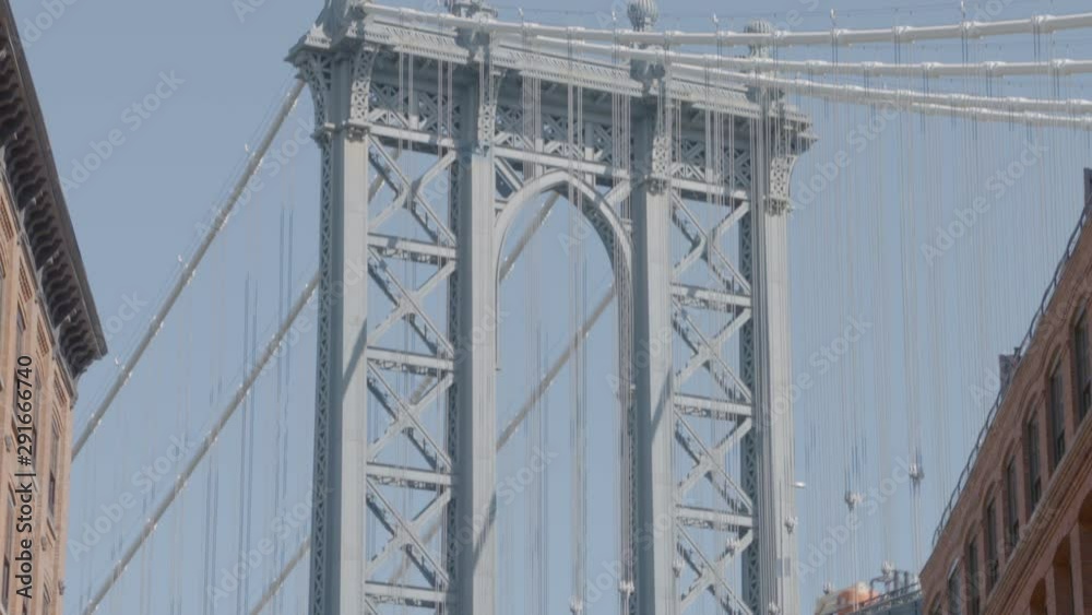 An upwards dolly shot of the Brookyln bridge through one of the city streets. An upwards dolly shot of the Brookyln bridge through one of the city streets.