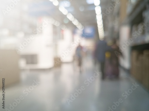 defocused images of environment and people shopping inside a hypermarket with added flares