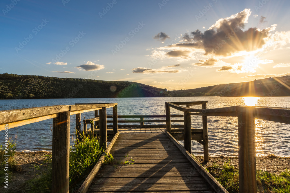 Views during the beautiful sunset on the dock for fishing of the Selga de Ordas reservoir in Leon, Spain Views during the beautiful sunset on the dock for fishing of the Selga de Ordas reservoir in Leon, Spain