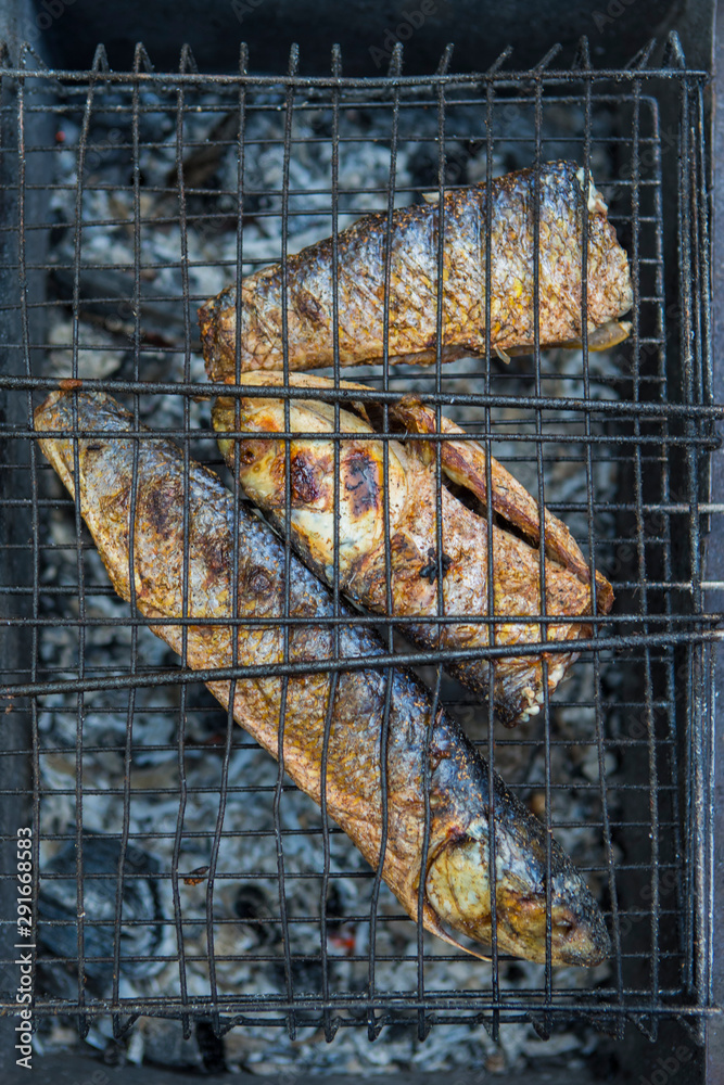 Food Concepts. Closeup of Spiced Mullet Seafood Preparing on Grill.