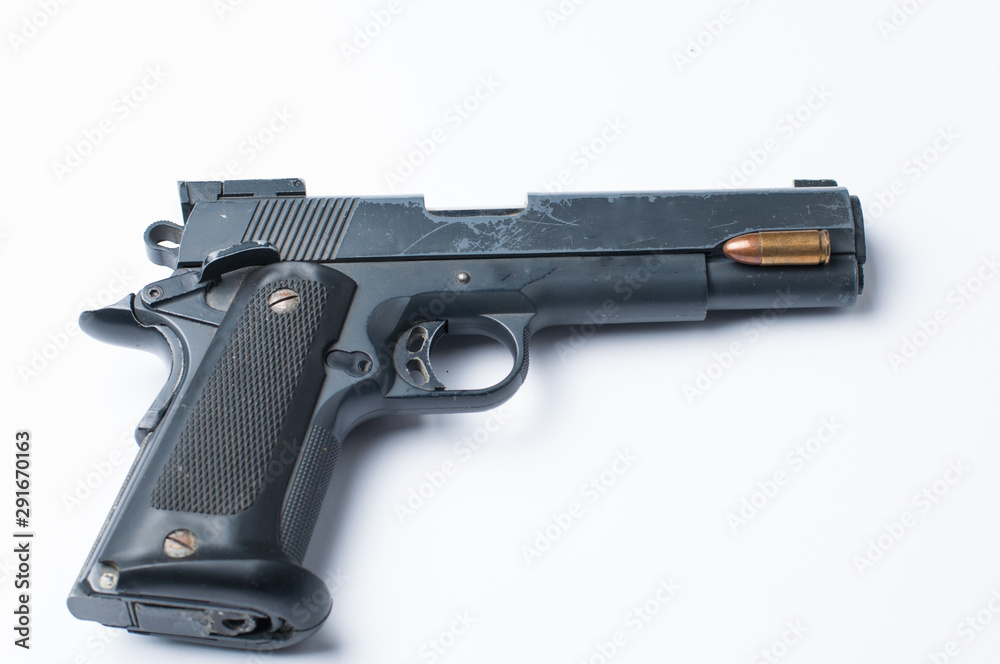 Gun and bullet isolated on white background.Copy space Gun and bullet isolated on white background.Copy space
