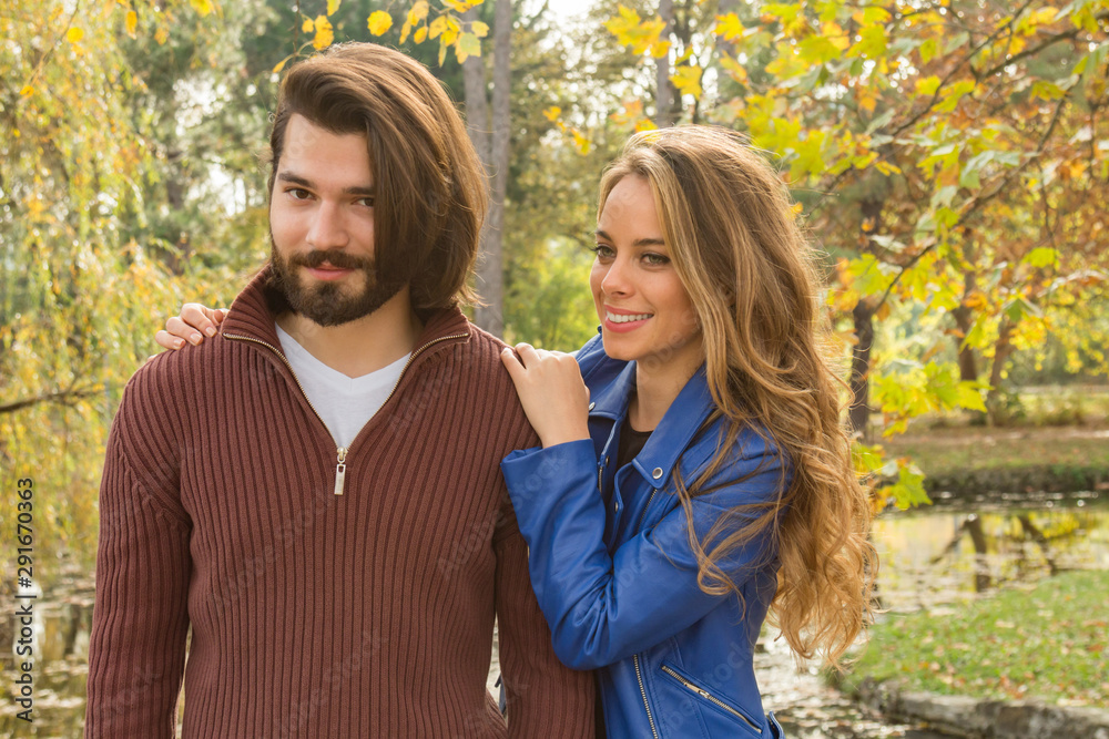 Fototapeta premium Couple in the park enjoying nice autumn time.