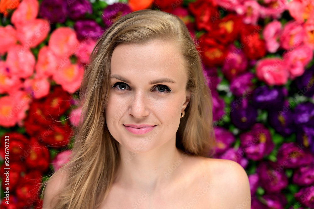Close-up portrait of a beautiful smiling girl with long hair and excellent skin on a colorful background. Close-up portrait of a beautiful smiling girl with long hair and excellent skin on a colorful background.