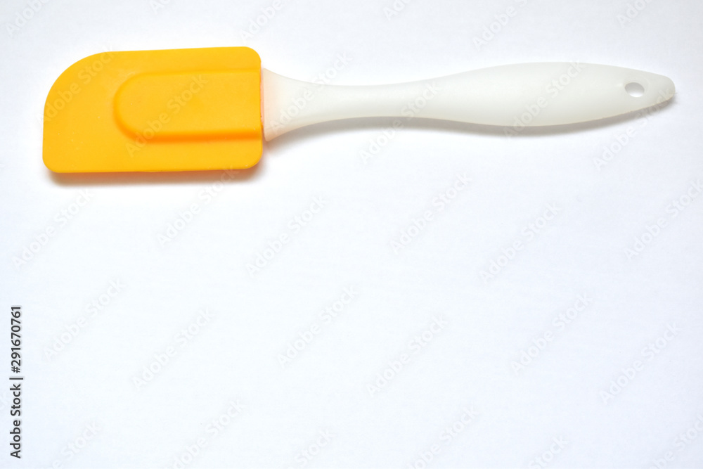 yellow culinary spatula on a white background yellow culinary spatula on a white background