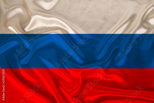 photo of the national flag of Russia on a luxurious texture of satin, silk with waves, folds and highlights, close-up, copy space, concept of travel, economy and state policy, illustration