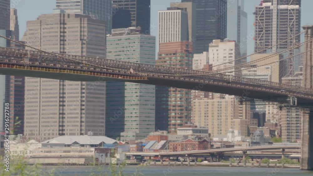 A low angle of the underneath of Brookyln Bridge showing the structure and the people walking along the underpas. A low angle of the underneath of Brookyln Bridge showing the structure and the people walking along the underpas.